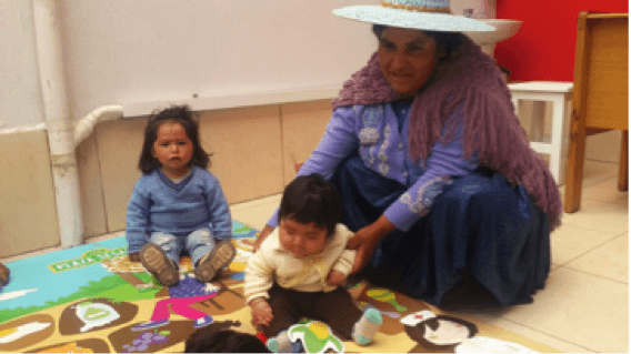 A Pro Mujer client plays a game with her young child in Pro Mujer’s new Children’s Corner. 