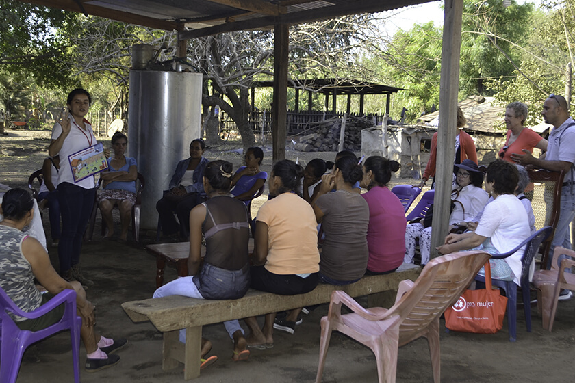 The Communal Association "Sagrada Familia" gathers ata client's home for a repayment session.